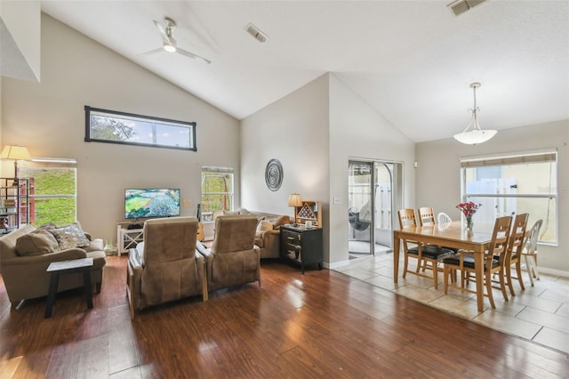 living room with ceiling fan, hardwood / wood-style flooring, and high vaulted ceiling