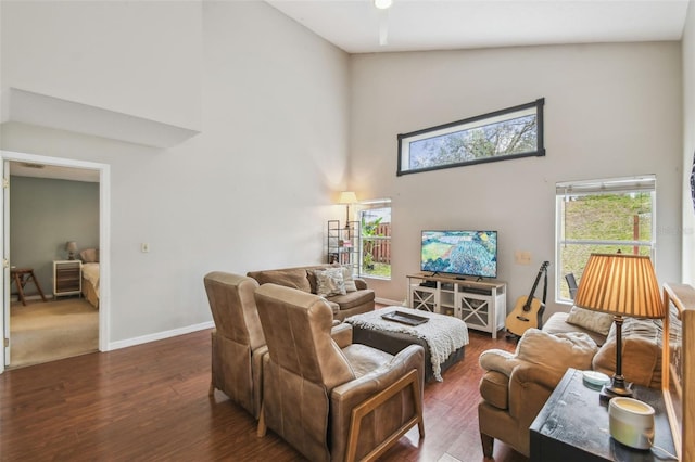 living room featuring dark hardwood / wood-style flooring and high vaulted ceiling