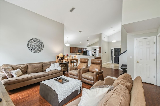 living room with dark hardwood / wood-style floors and high vaulted ceiling