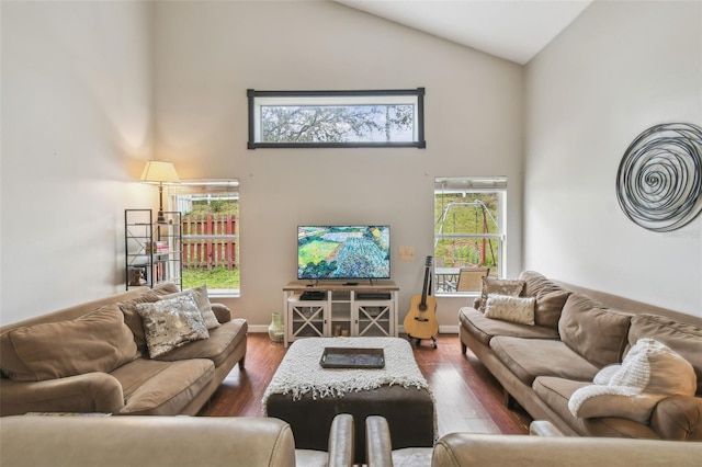 living room with high vaulted ceiling and dark wood-type flooring