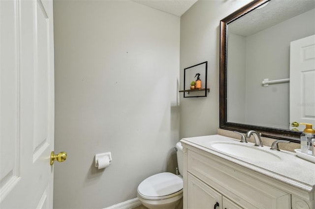 bathroom with toilet and vanity