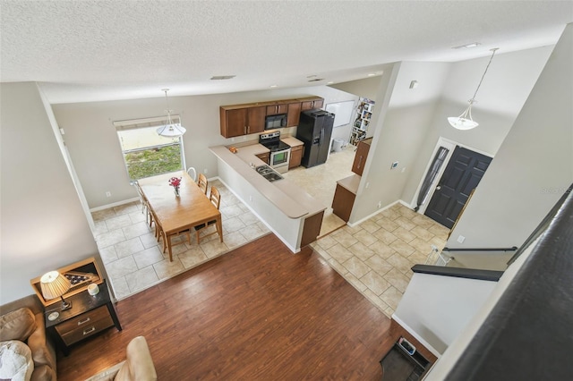 interior space featuring a textured ceiling and light hardwood / wood-style flooring