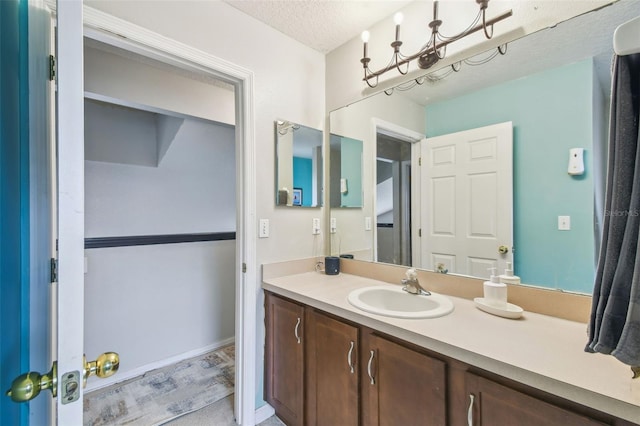 bathroom with a textured ceiling and vanity