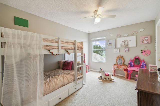 carpeted bedroom featuring a textured ceiling and ceiling fan