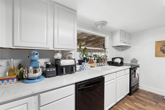 kitchen with black appliances, decorative backsplash, white cabinetry, and sink