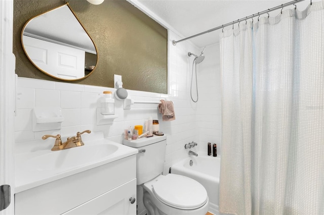 full bathroom with vanity, shower / bath combo, toilet, and tile walls