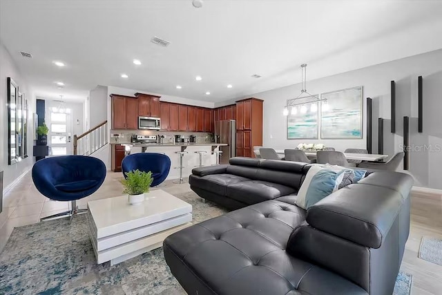 living room featuring a notable chandelier