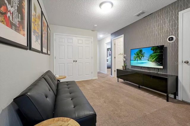 carpeted living room featuring a textured ceiling