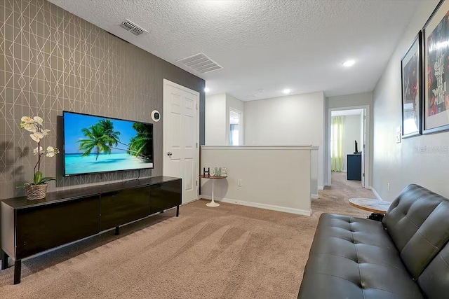 carpeted living room featuring a textured ceiling