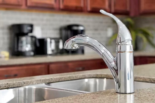 room details featuring light stone counters and sink