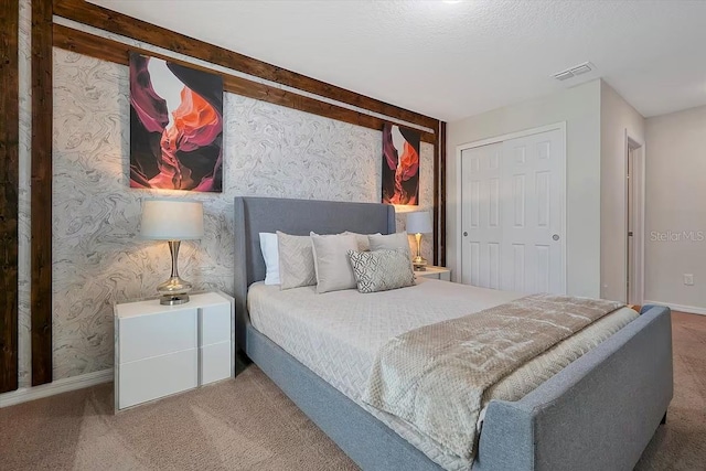 bedroom featuring carpet and a closet