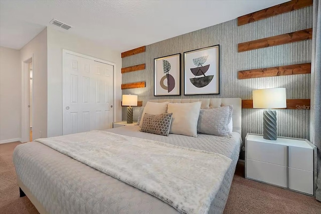 carpeted bedroom featuring a closet