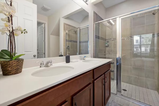 bathroom featuring vanity and a shower with shower door