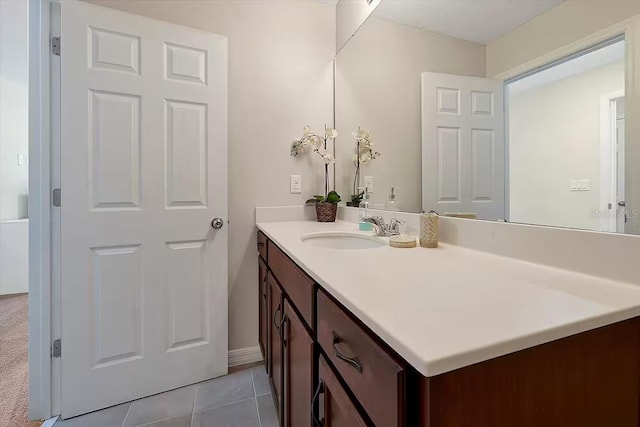 bathroom with tile patterned flooring and vanity