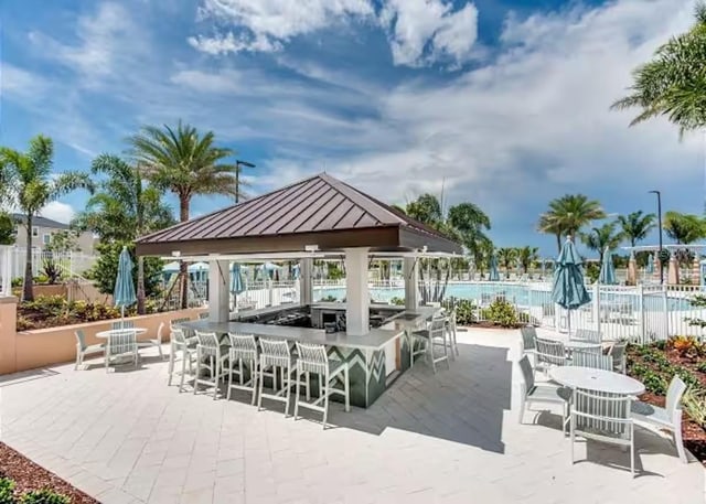 view of patio / terrace featuring a gazebo and a community pool