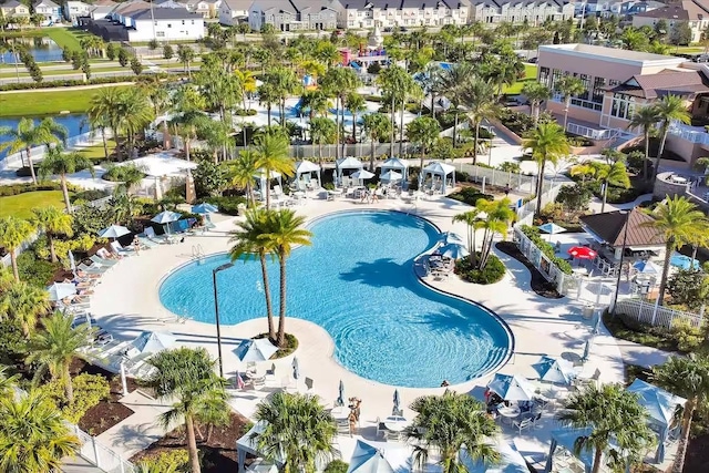 view of pool featuring a patio area and a water view