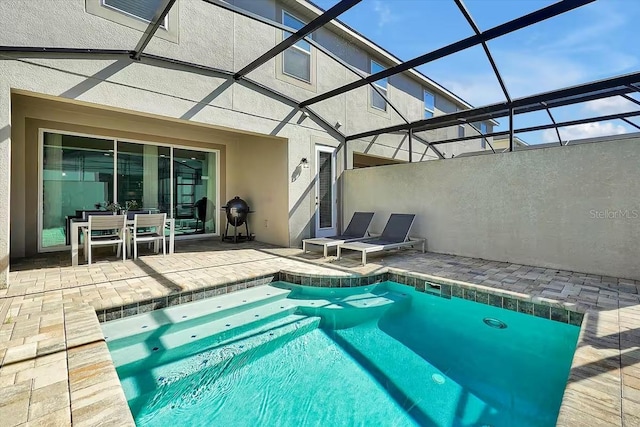 view of pool with a patio area and a lanai