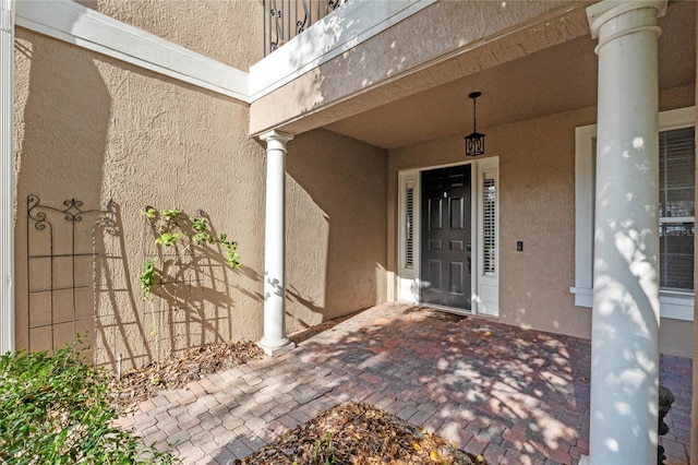 view of exterior entry featuring covered porch