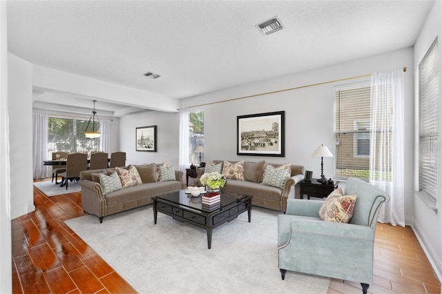 living room with a healthy amount of sunlight and a textured ceiling