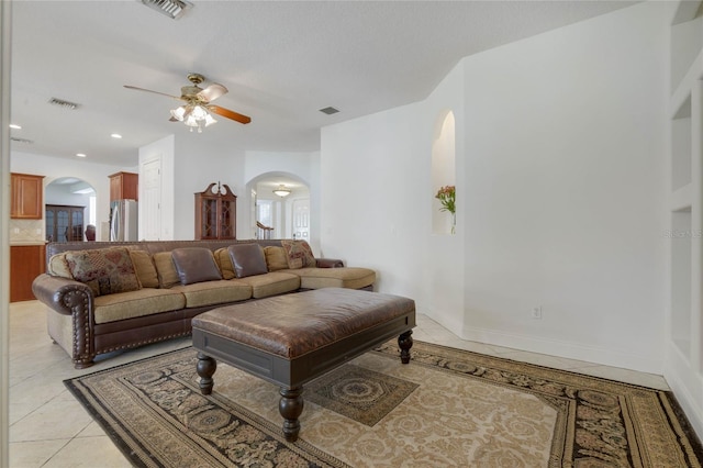 living room featuring ceiling fan and light tile patterned floors