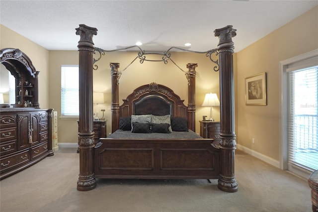 carpeted bedroom featuring multiple windows