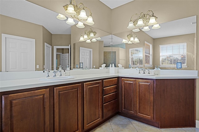 bathroom featuring tile patterned floors, vanity, and a chandelier