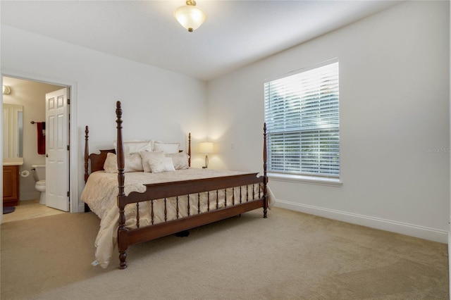 carpeted bedroom with connected bathroom