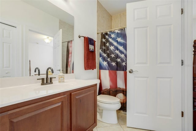 bathroom featuring tile patterned flooring, vanity, and toilet