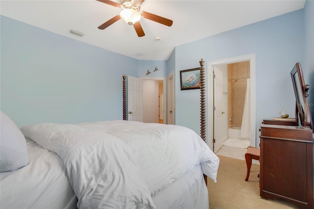 bedroom featuring connected bathroom, light colored carpet, and ceiling fan