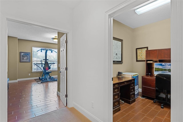 office area with a textured ceiling