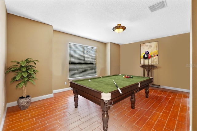 rec room with hardwood / wood-style floors, a textured ceiling, and pool table