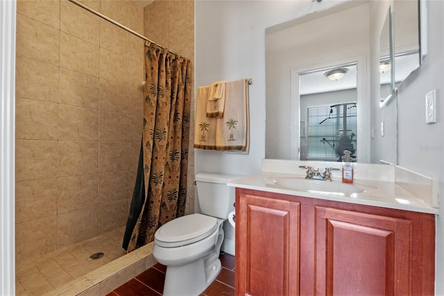 bathroom with curtained shower, vanity, and toilet