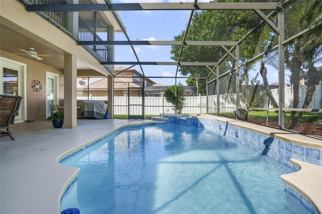 view of pool with a patio, ceiling fan, a lanai, and a grill