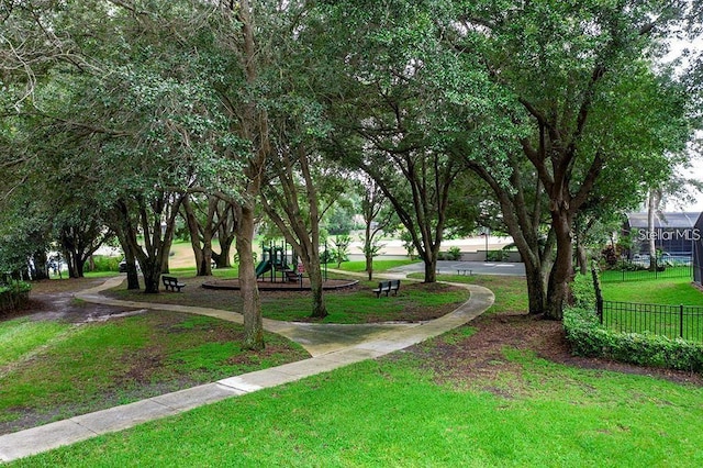 view of community featuring a lawn and a playground