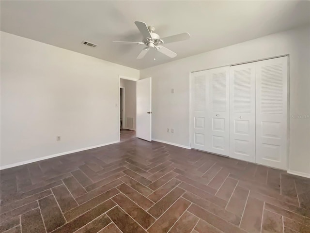 unfurnished bedroom with ceiling fan and a closet