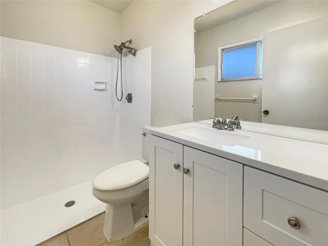 bathroom with tile patterned flooring, a shower, vanity, and toilet