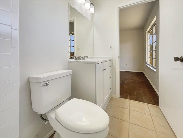 bathroom featuring tile patterned flooring, vanity, and toilet