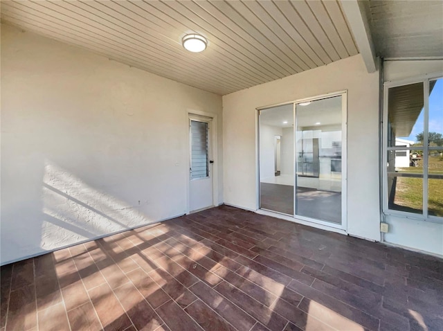 unfurnished sunroom with lofted ceiling with beams and wood ceiling