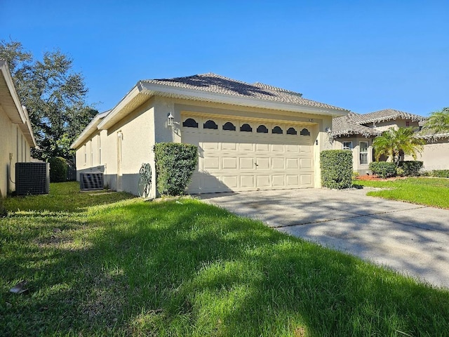 view of side of property with a yard, a garage, and central AC unit