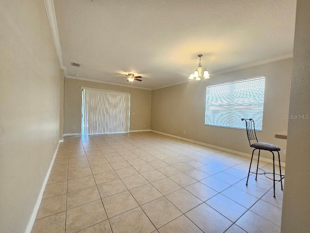 tiled spare room with a textured ceiling, crown molding, and ceiling fan with notable chandelier