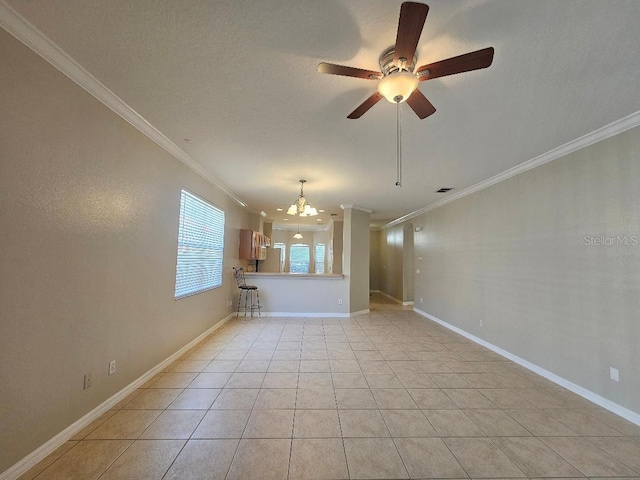 unfurnished room with light tile patterned floors, ceiling fan with notable chandelier, and crown molding