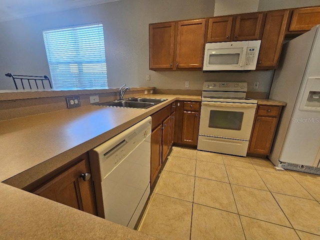 kitchen featuring sink, light tile patterned floors, and white appliances