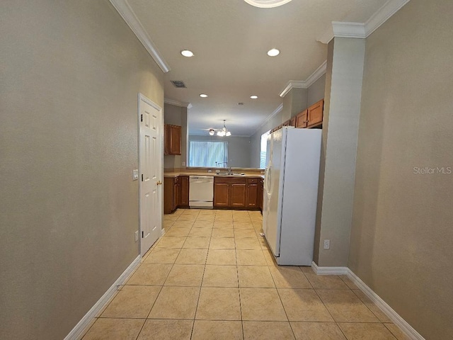 kitchen featuring kitchen peninsula, white appliances, ornamental molding, and light tile patterned flooring