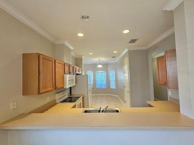 kitchen with kitchen peninsula, ornamental molding, white appliances, sink, and light tile patterned floors