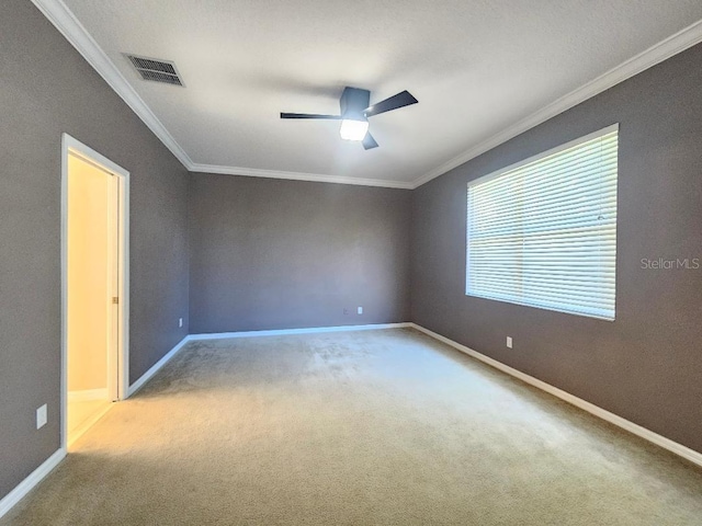 carpeted empty room with ceiling fan and ornamental molding