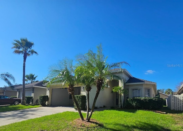 view of front of property featuring a garage and a front yard