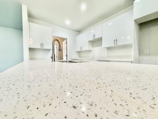 kitchen with white cabinets and sink