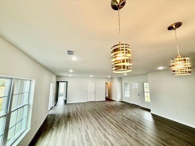 unfurnished living room featuring hardwood / wood-style floors and a healthy amount of sunlight