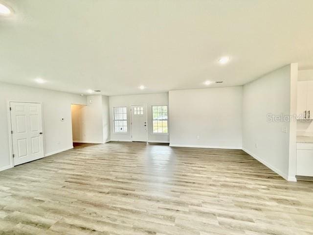 unfurnished living room featuring light hardwood / wood-style floors