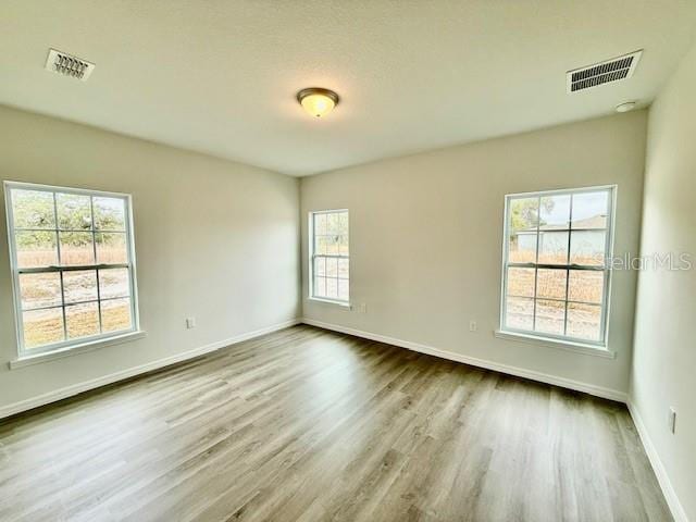 unfurnished room with hardwood / wood-style floors